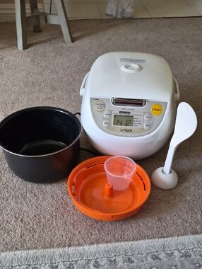 Tiger White Rice Cooker with Orange Steam Tray and Black Inner Pot